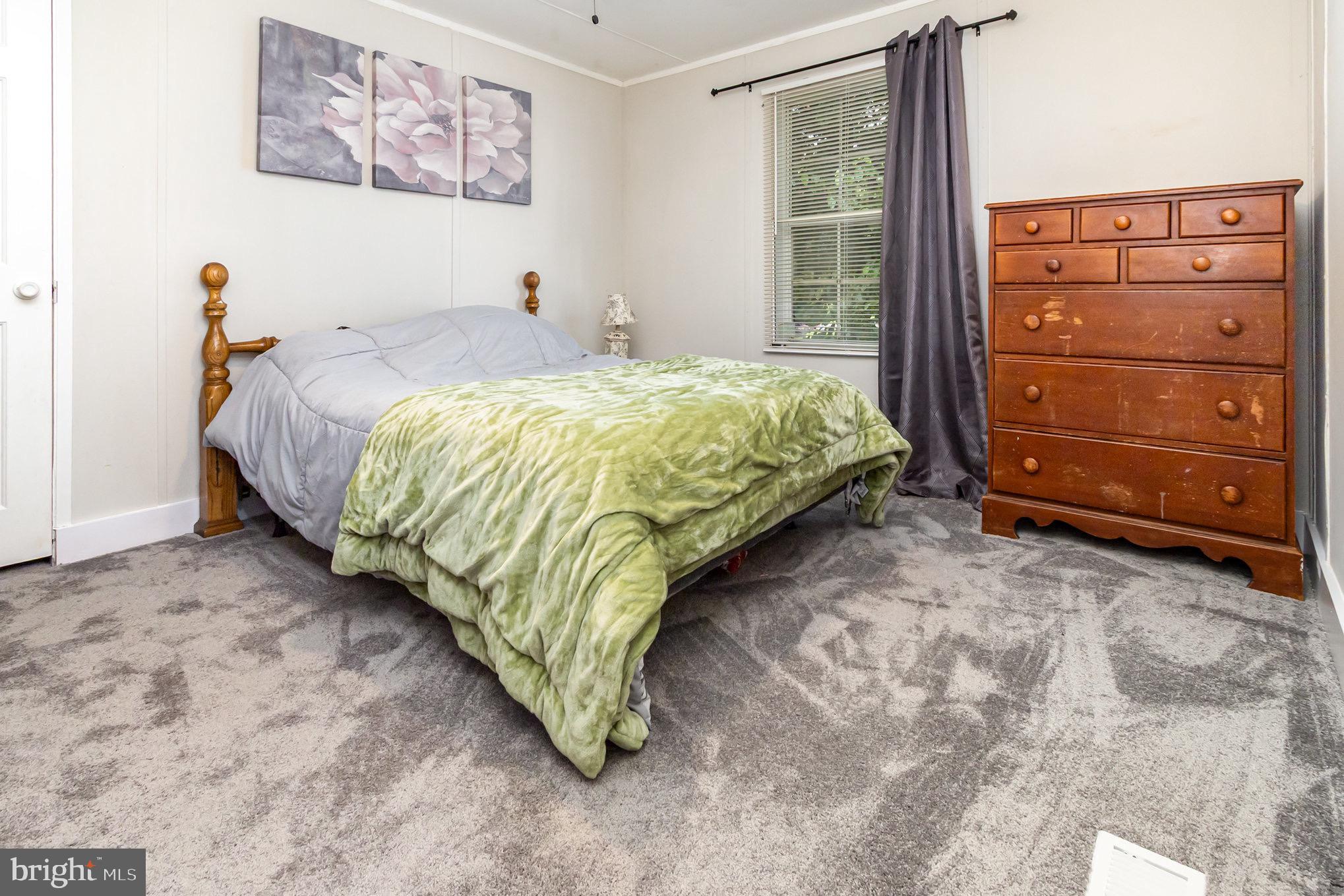 4041 Conowingo Road, Unit 30 Darlington, MD 21034 - Photo 22 of 40 a bed sitting in a bedroom next to a window