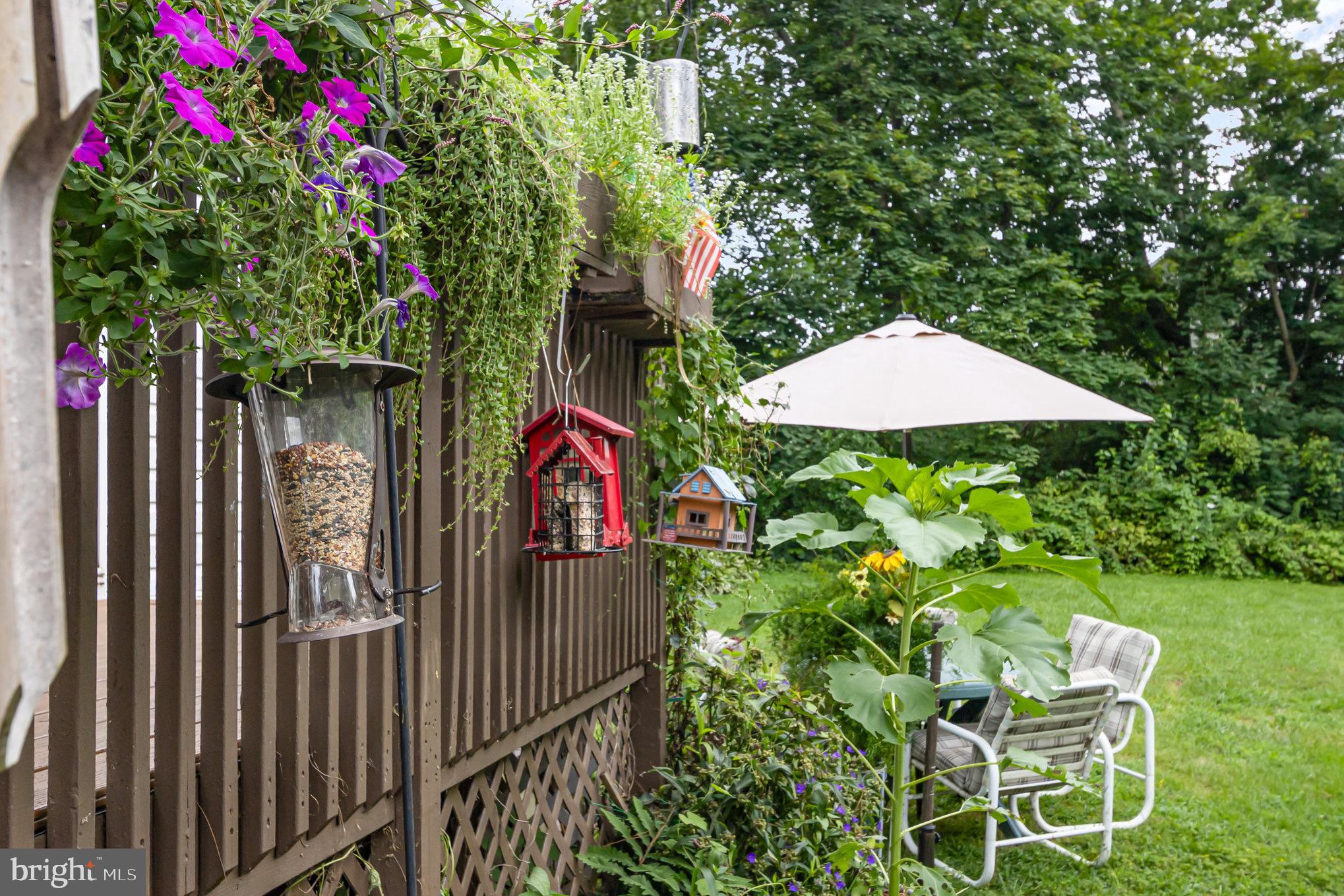 4041 Conowingo Road, Unit 30 Darlington, MD 21034 - Photo 30 of 40 a backyard of a house with table and chairs under an umbrella