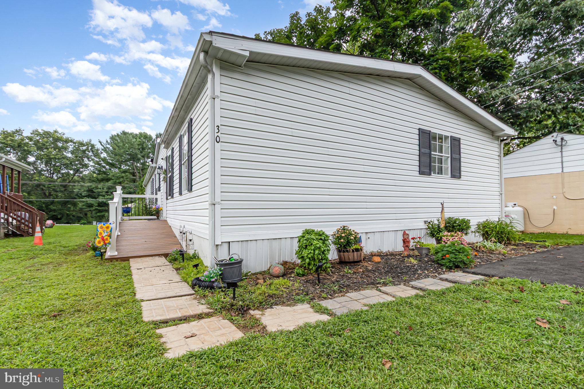 4041 Conowingo Road, Unit 30 Darlington, MD 21034 - Photo 34 of 40 a front view of a house with garden