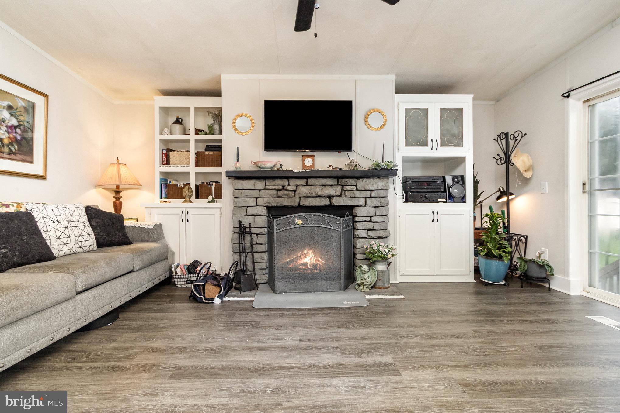 4041 Conowingo Road, Unit 30 Darlington, MD 21034 - Photo 9 of 40 a living room with furniture a flat screen tv and a fireplace