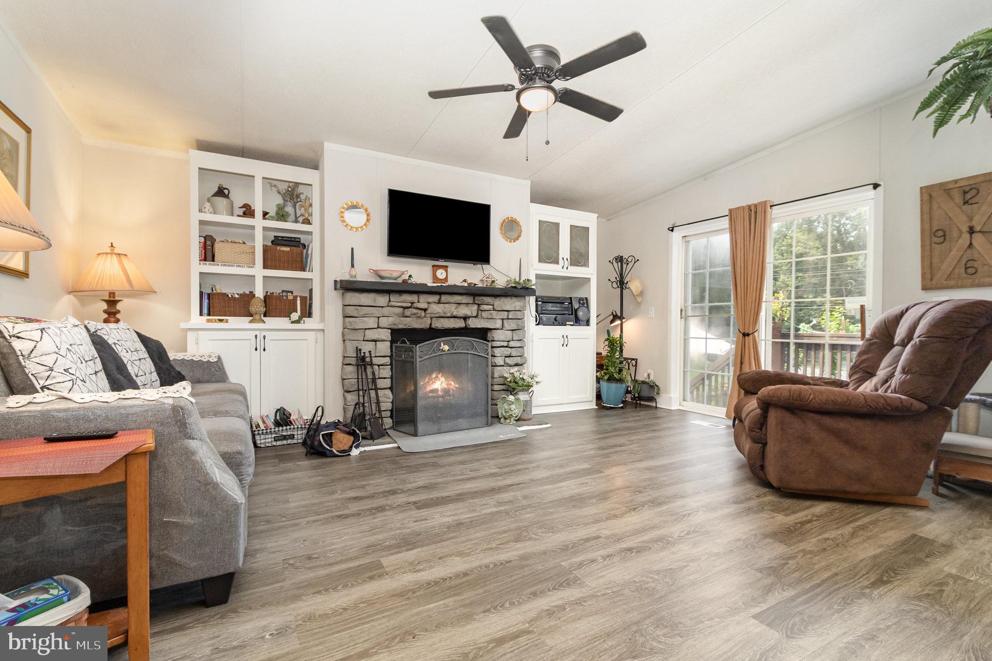 4041 Conowingo Road, Unit 30 Darlington, MD 21034 - Photo 10 of 40 a living room with furniture a flat screen tv and a fireplace
