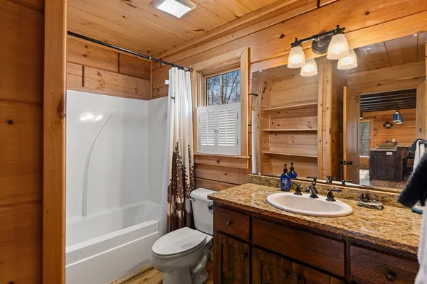 a view of a house with a yard and balcony