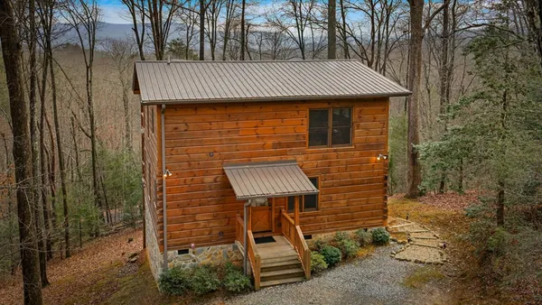 a room with pool table and windows