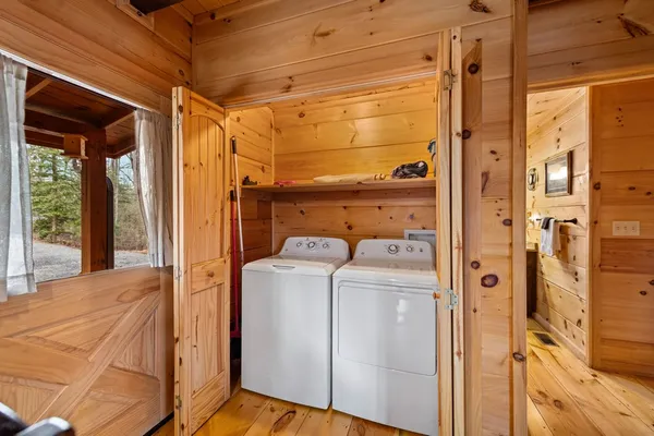 a bathroom with a granite countertop sink a toilet a mirror and shower