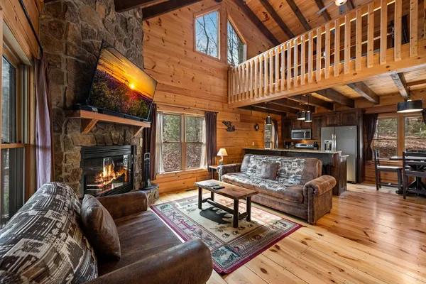 a bedroom with a bed a dresser and flat screen tv