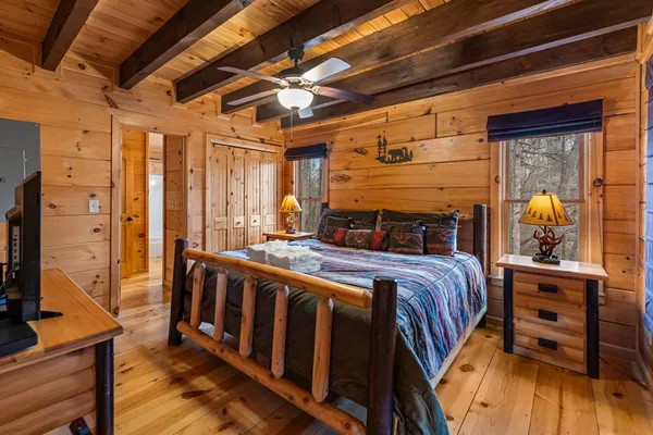 a living room with furniture a fireplace and a floor to ceiling window