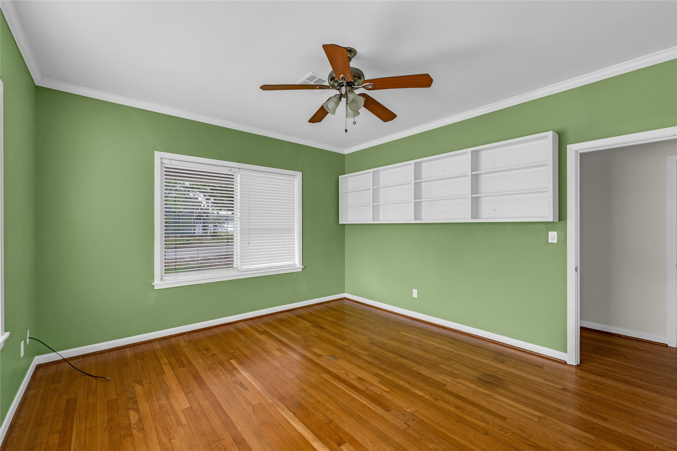 2527 Avenue G Rosenberg, TX 77471 - Photo 11 of 35 a view of empty room with wooden floor and fan