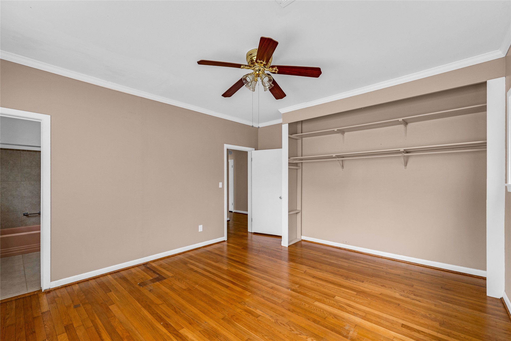 2527 Avenue G Rosenberg, TX 77471 - Photo 13 of 35 a view of empty room with wooden floor and ceiling fan