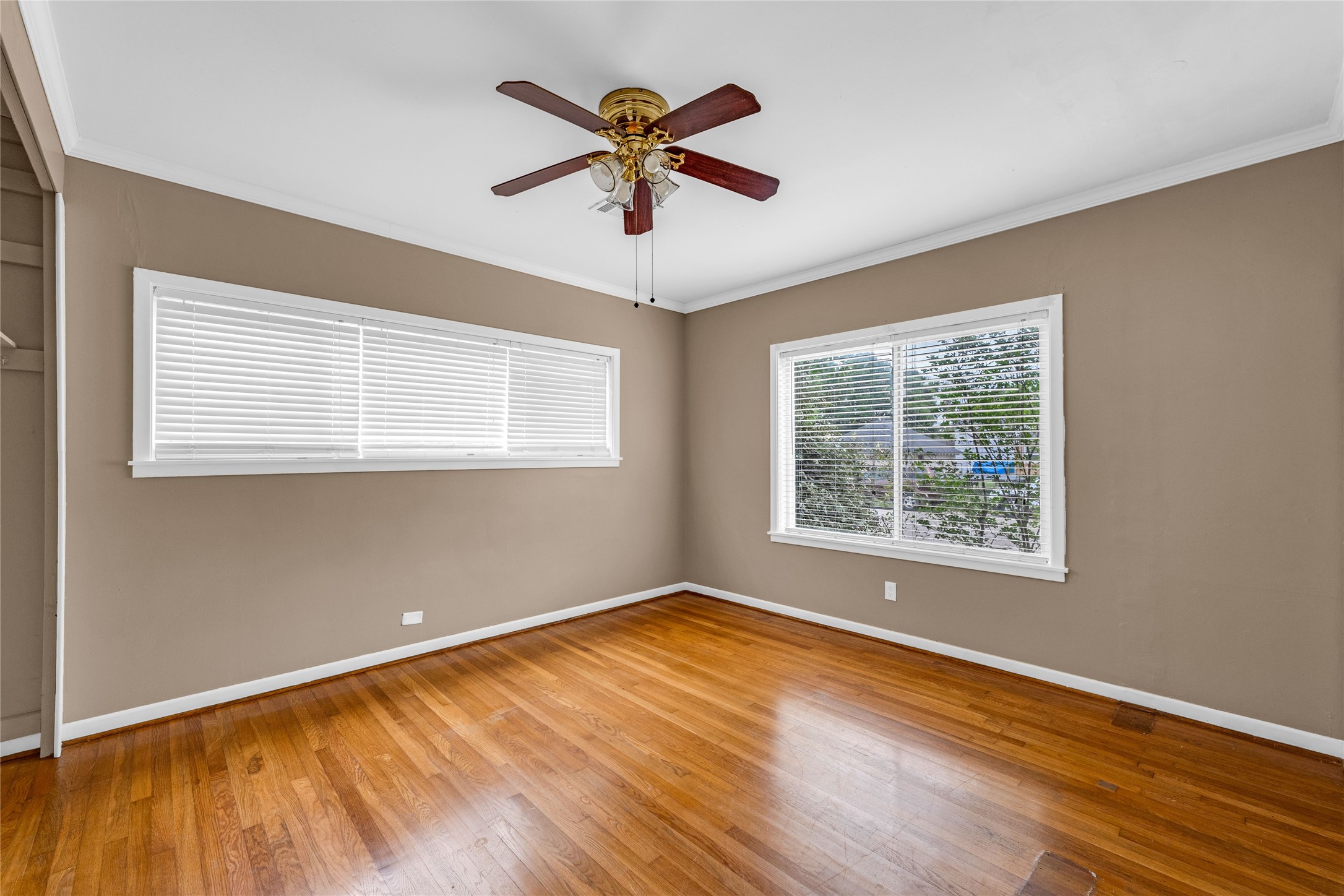 2527 Avenue G Rosenberg, TX 77471 - Photo 16 of 35 a view of a room with wooden floor and ceiling fan