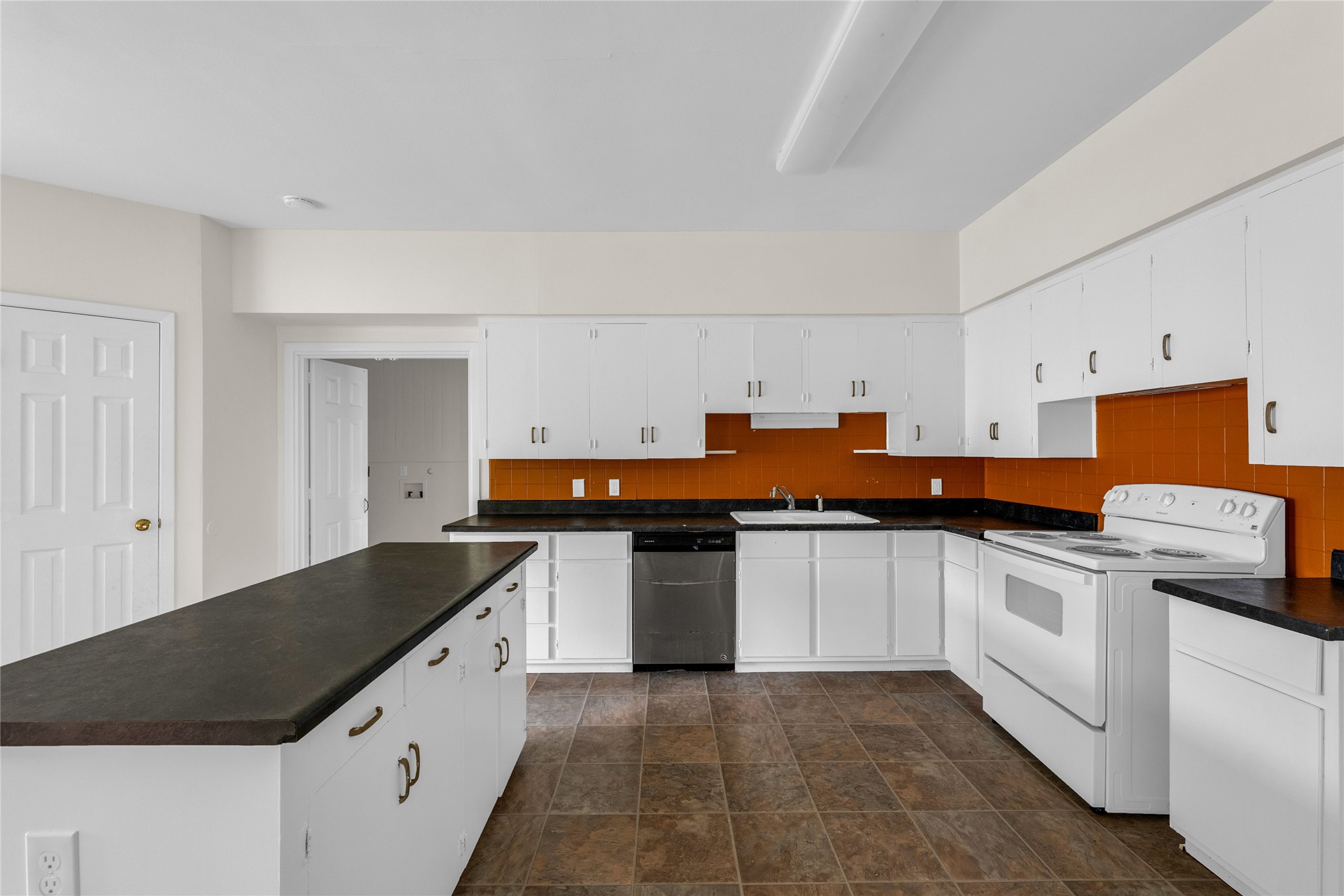 2527 Avenue G Rosenberg, TX 77471 - Photo 17 of 35 a kitchen with stainless steel appliances and white cabinets