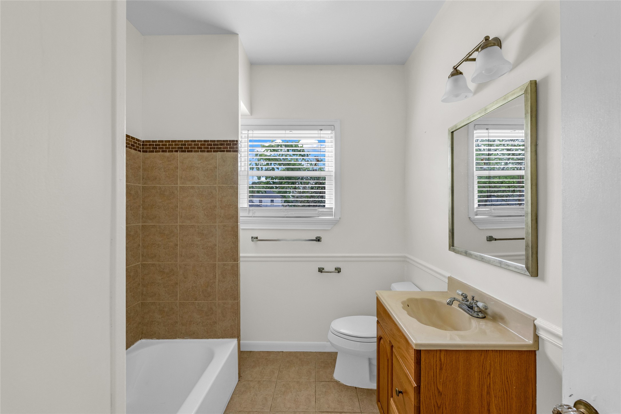 2527 Avenue G Rosenberg, TX 77471 - Photo 19 of 35 a bathroom with a sink a toilet and bathtub
