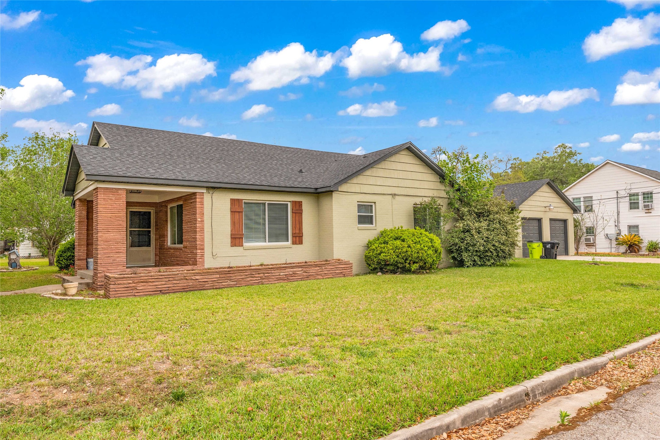 2527 Avenue G Rosenberg, TX 77471 - Photo 2 of 35 a front view of a house with garden