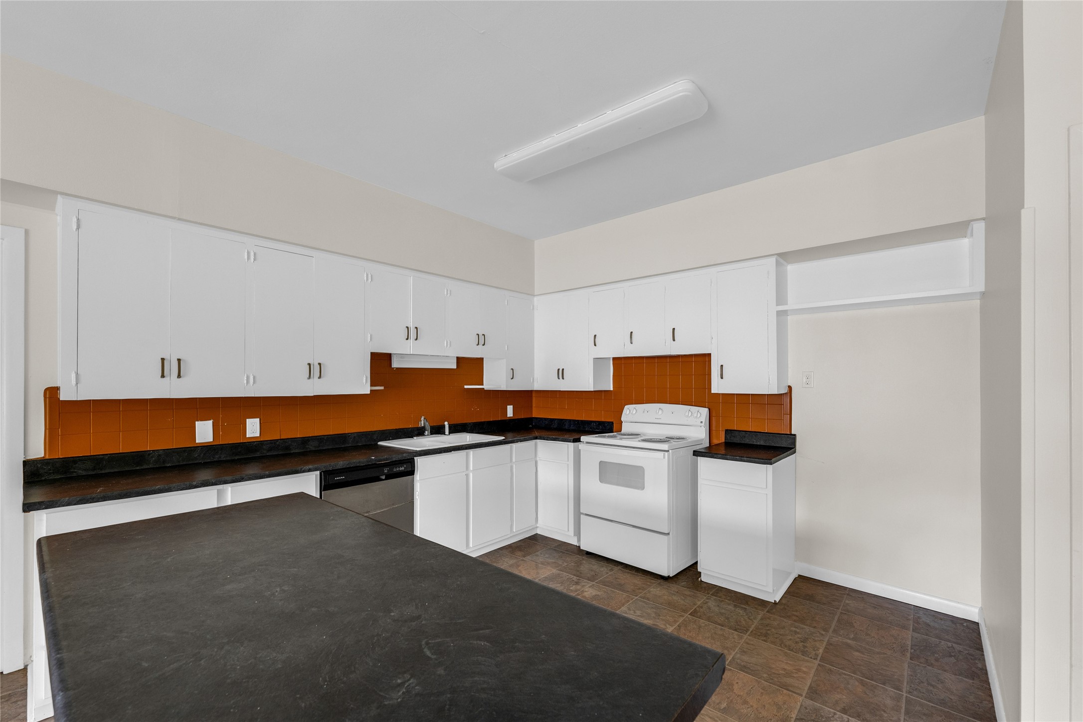2527 Avenue G Rosenberg, TX 77471 - Photo 21 of 35 a kitchen with stainless steel appliances a stove top oven