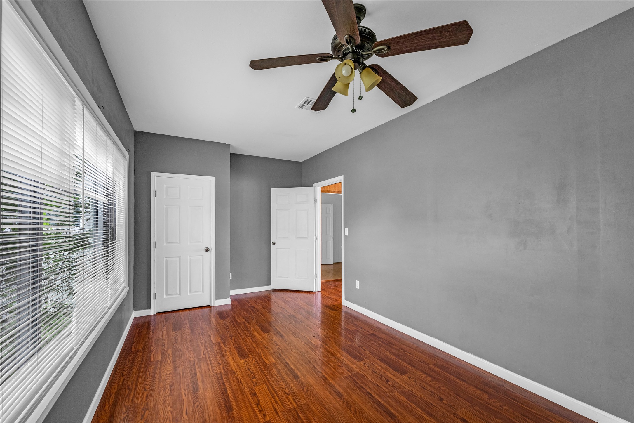 2527 Avenue G Rosenberg, TX 77471 - Photo 23 of 35 wooden floor in an empty room with a window