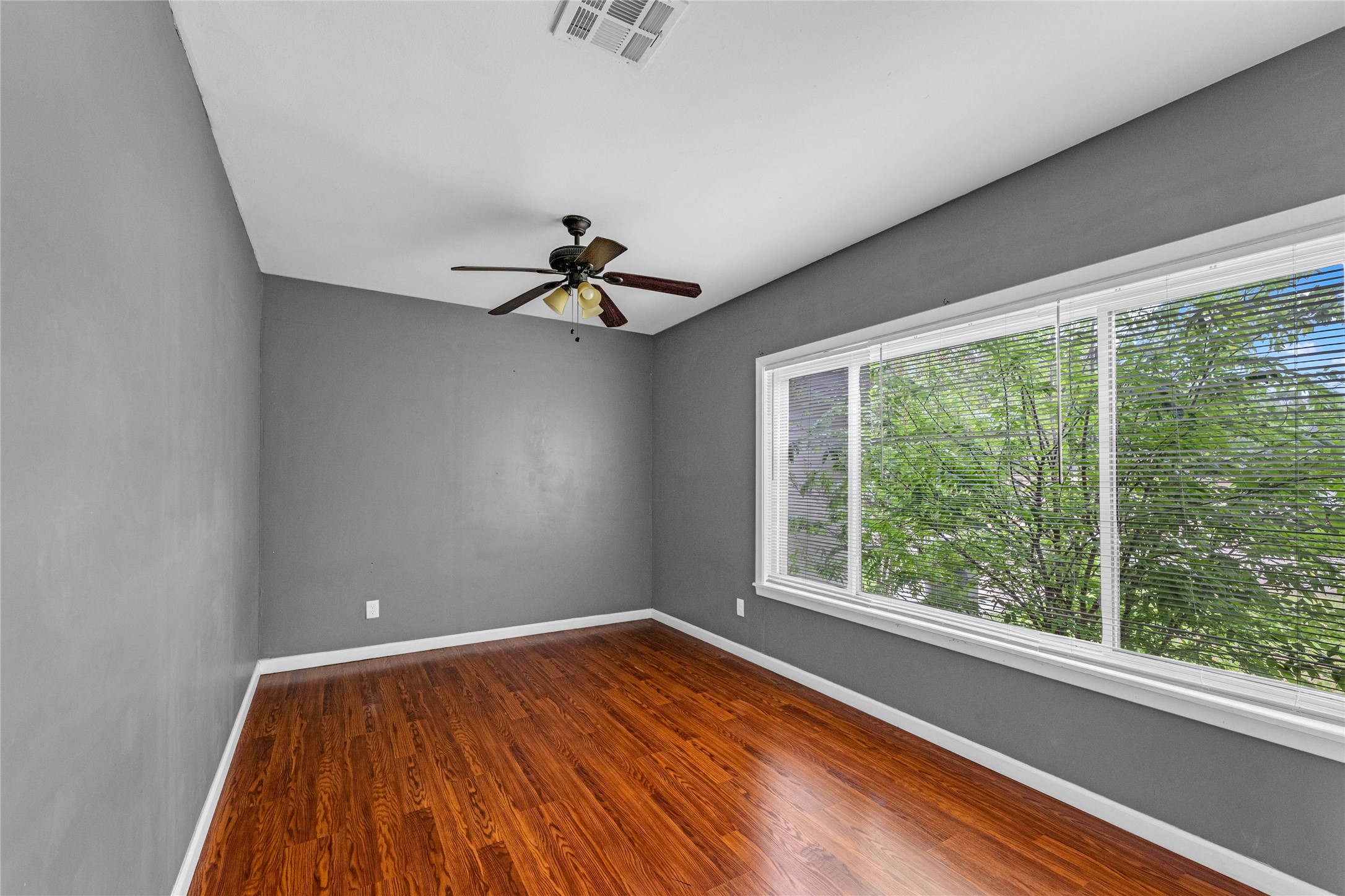 2527 Avenue G Rosenberg, TX 77471 - Photo 24 of 35 a view of room with window ceiling fan and hardwood floor