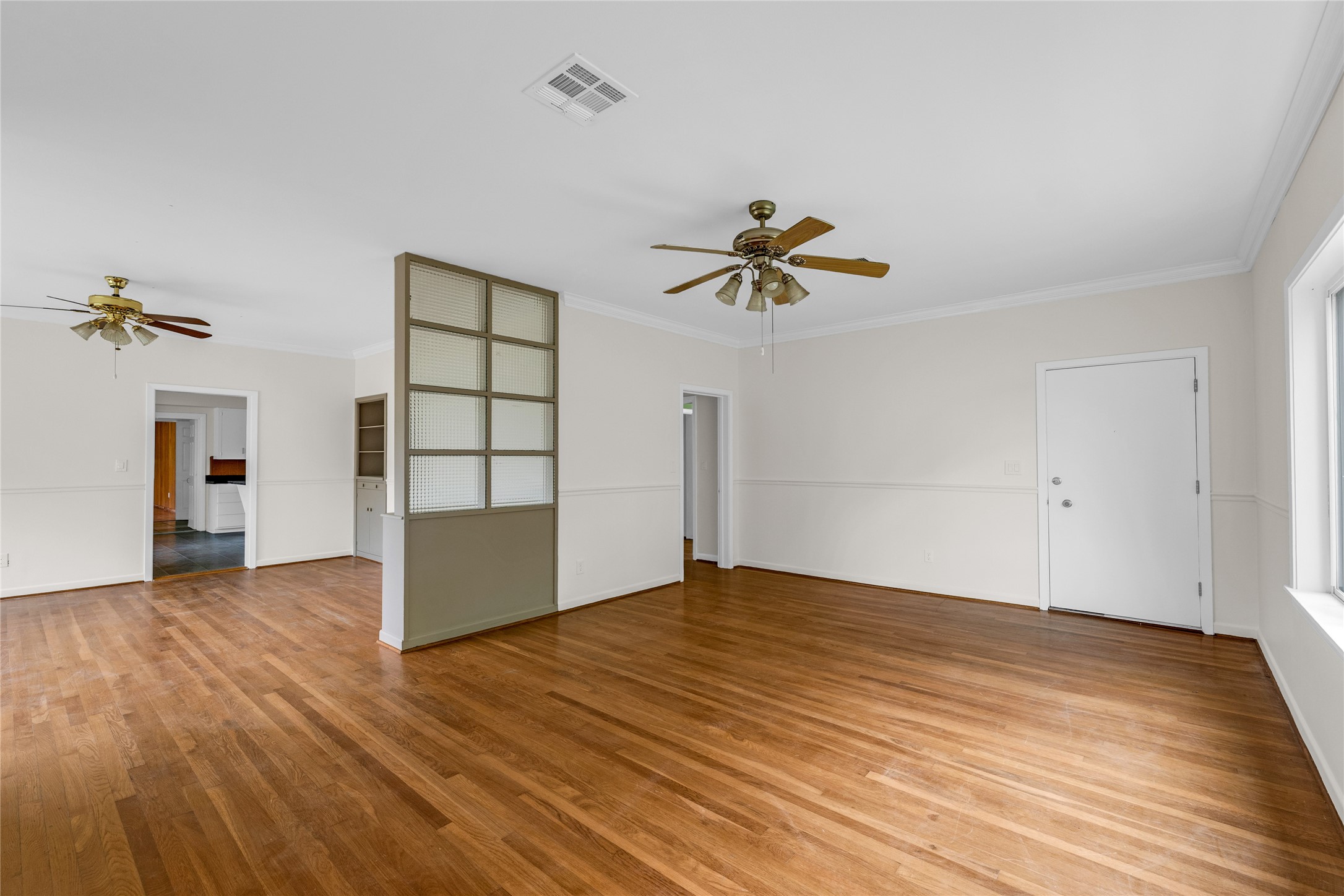 2527 Avenue G Rosenberg, TX 77471 - Photo 5 of 35 a view of empty room with wooden floor and fan