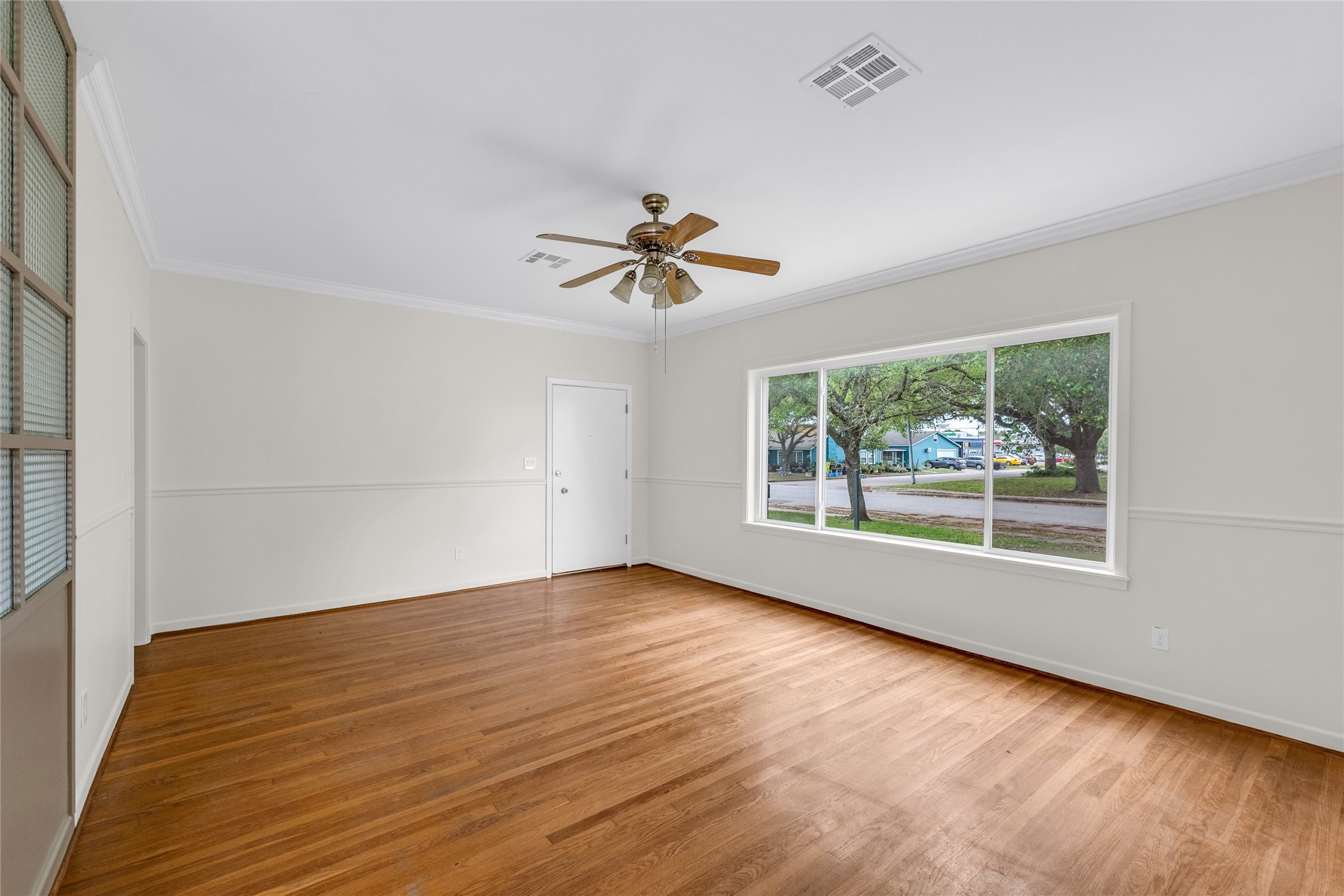 2527 Avenue G Rosenberg, TX 77471 - Photo 6 of 35 wooden floor in an empty room with a window