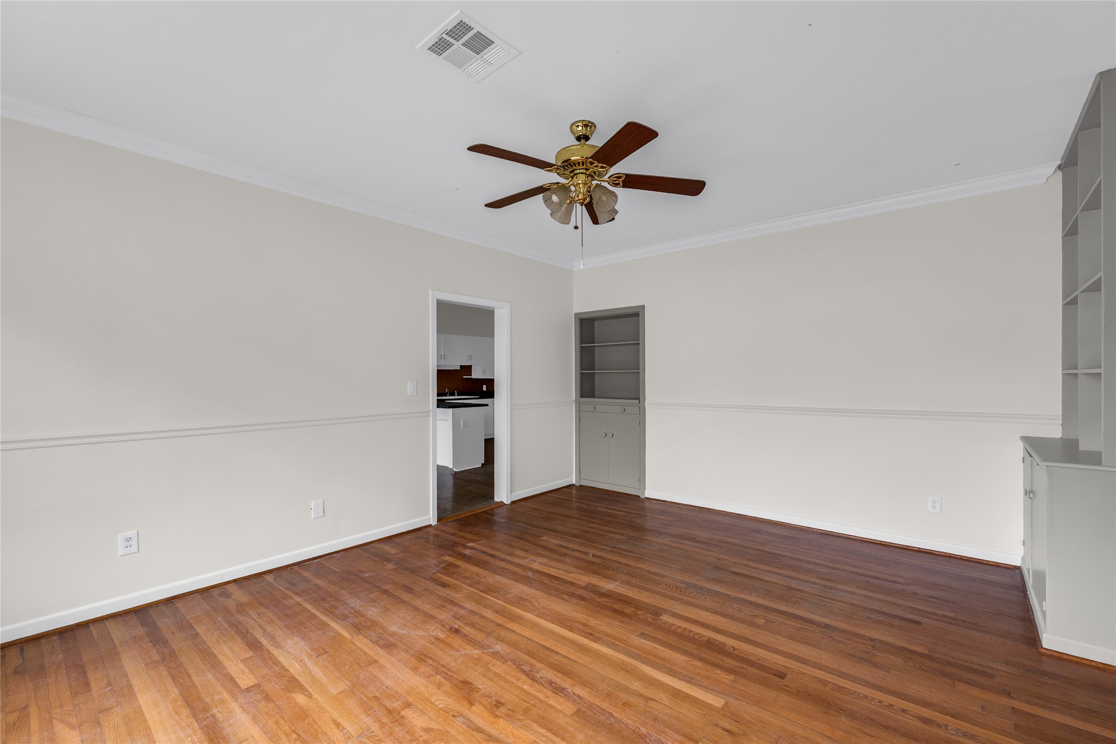 2527 Avenue G Rosenberg, TX 77471 - Photo 8 of 35 a view of a room with wooden floor and a ceiling fan