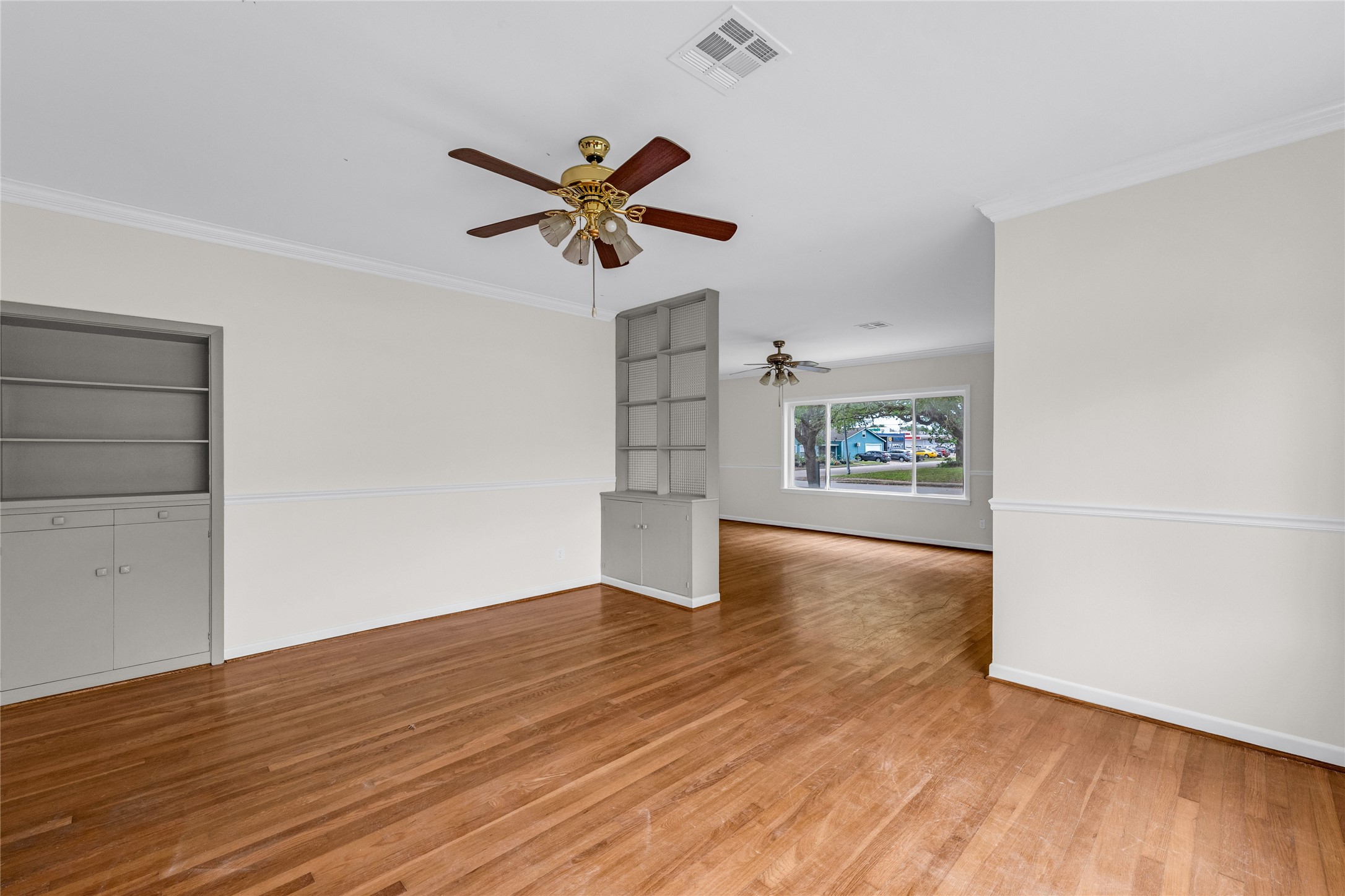 2527 Avenue G Rosenberg, TX 77471 - Photo 9 of 35 wooden floor in an empty room with a window