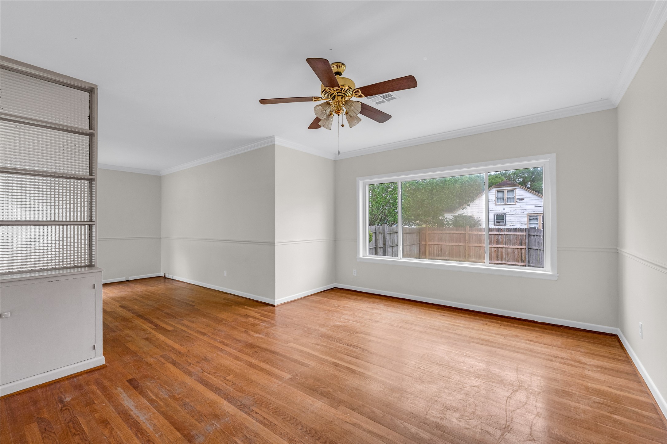 2527 Avenue G Rosenberg, TX 77471 - Photo 10 of 35 a view of empty room with wooden floor and fan