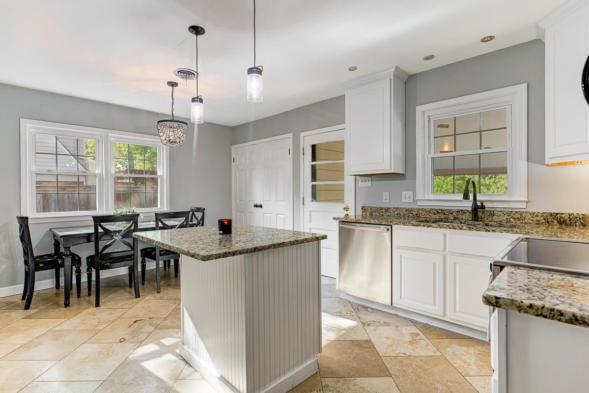 5676 Barfield Road Memphis, TN 38120 - Photo 8 of 19 Kitchen featuring a central island with beadboard paneling and granite countertop, access to carport