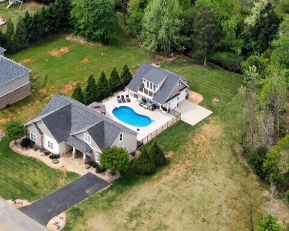 a front view of a house with a yard and trees