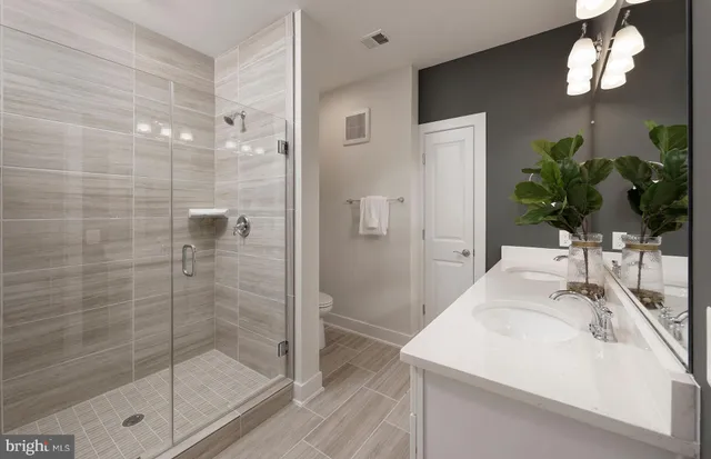 a bathroom with a sink a mirror and a shower