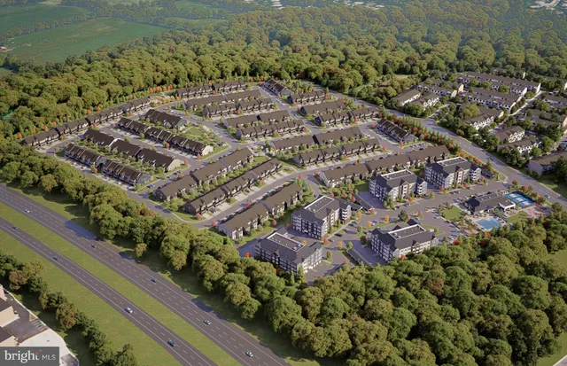 an aerial view of residential houses with outdoor space