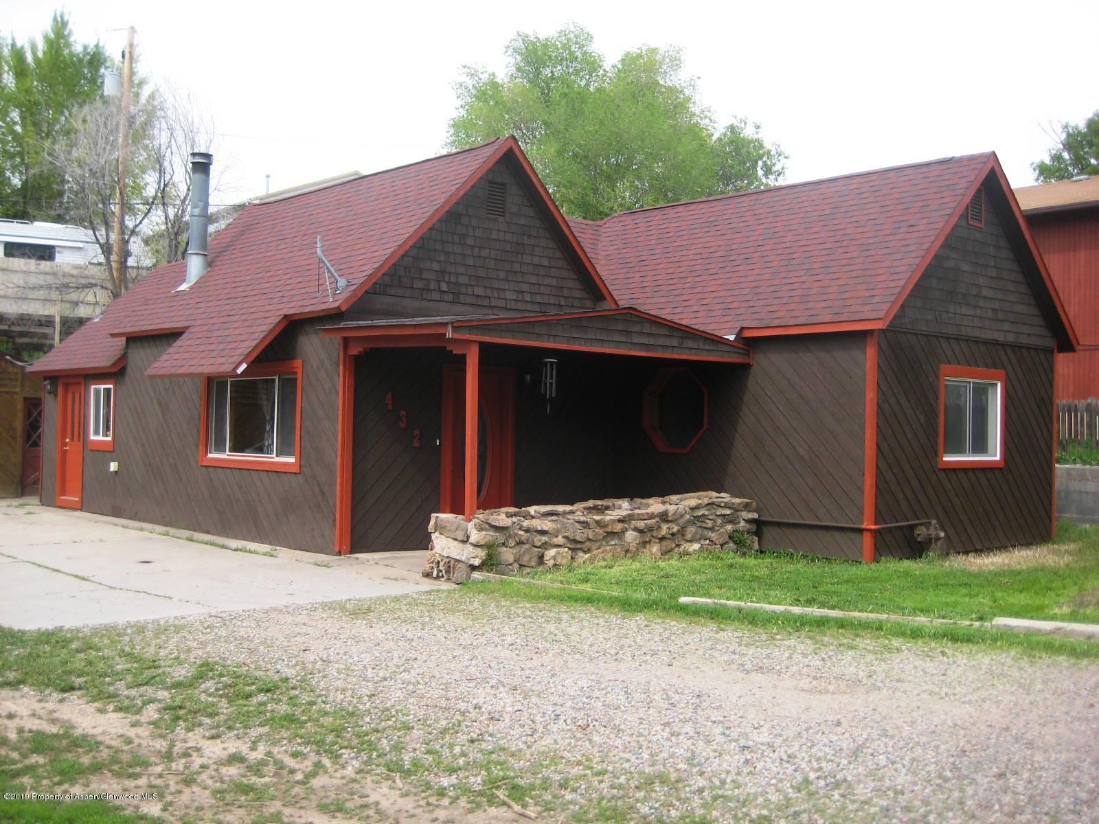432 East 3rd Street Rifle, CO 81650 - Photo 1 of 20 a front view of a house with a yard and garage