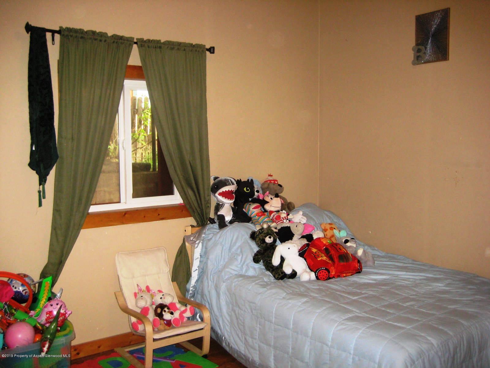 432 East 3rd Street Rifle, CO 81650 - Photo 12 of 20 a bedroom with a bed and a window