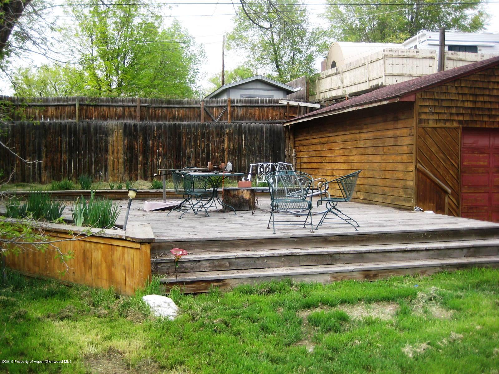 432 East 3rd Street Rifle, CO 81650 - Photo 18 of 20 a view of house with backyard outdoor seating and lake view