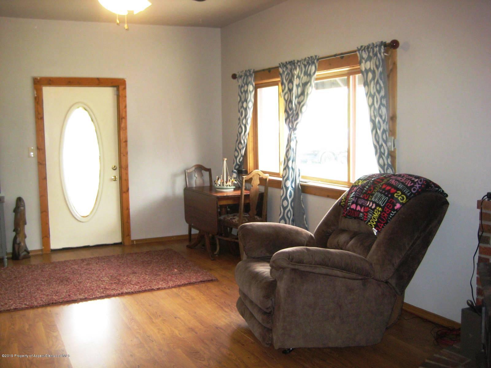 432 East 3rd Street Rifle, CO 81650 - Photo 7 of 20 a living room with furniture a window and a wooden floor