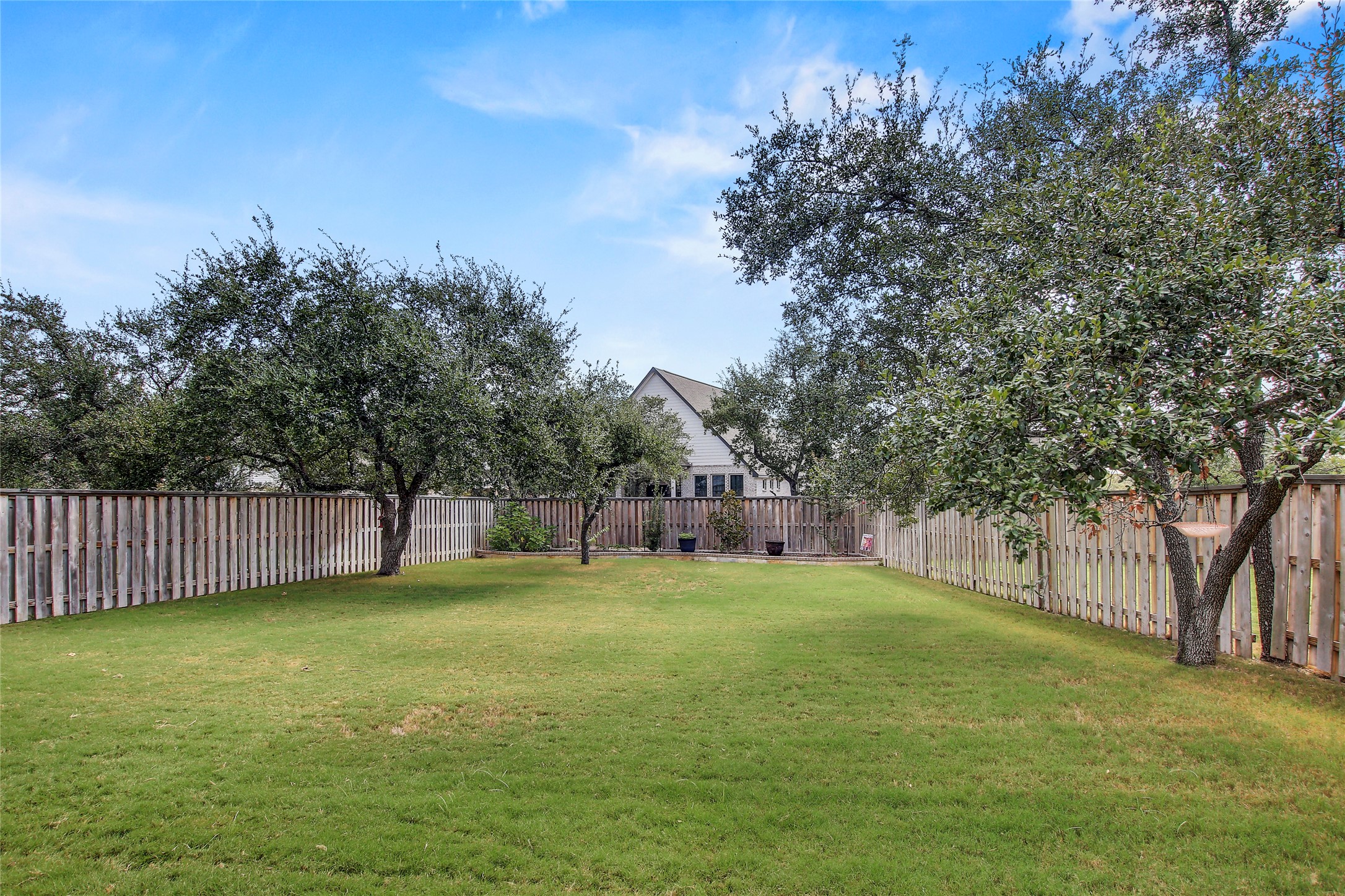 104 Millbend Road Georgetown, TX 78633 - Photo 40 of 40 A generously sized yard, fenced for seclusion, offers ample room for outdoor activities and relaxation.