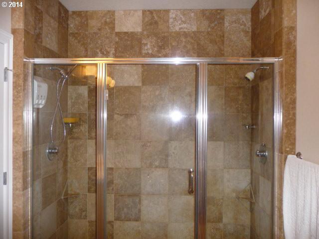 4403 West Burnside Road Portland, OR 97210 - Photo 13 of 16 a bathroom with a glass shower door