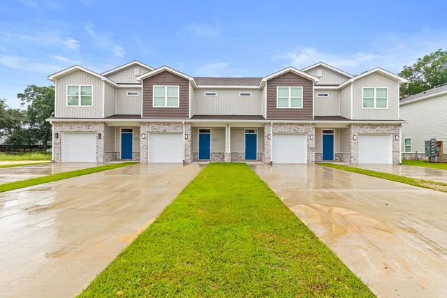a front view of a house with swimming pool and glass windows