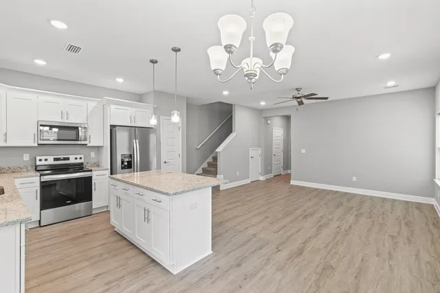a kitchen with a stove a refrigerator and a fireplace