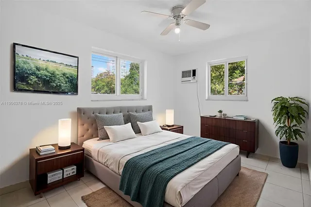 a bedroom with bed couch and window