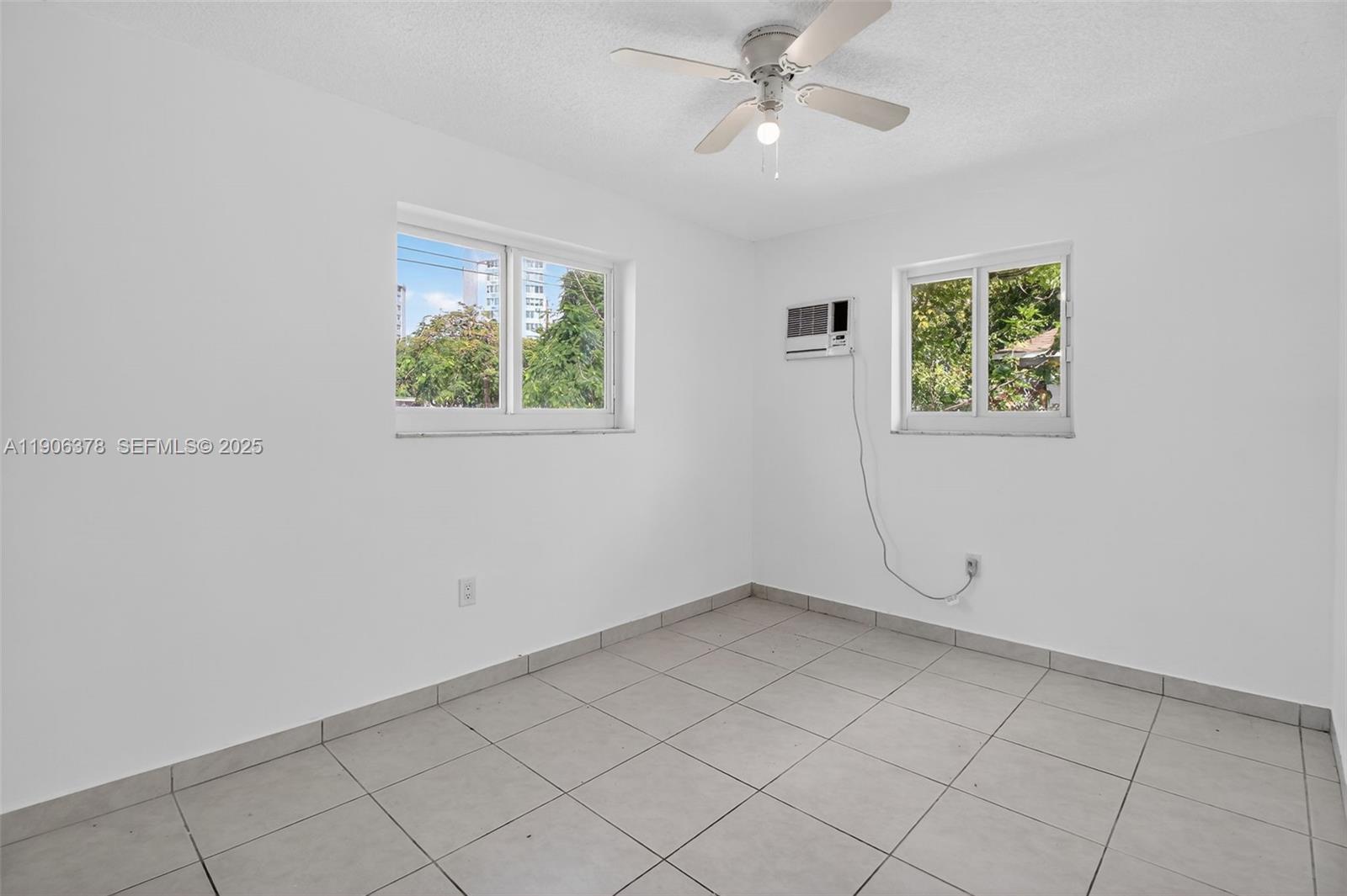 1864 Northwest 28th Street, Unit 1 Miami, FL 33142 - Photo 12 of 16 wooden floor in an empty room with a window