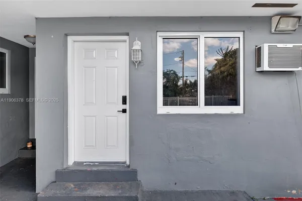 a view of a door and a window