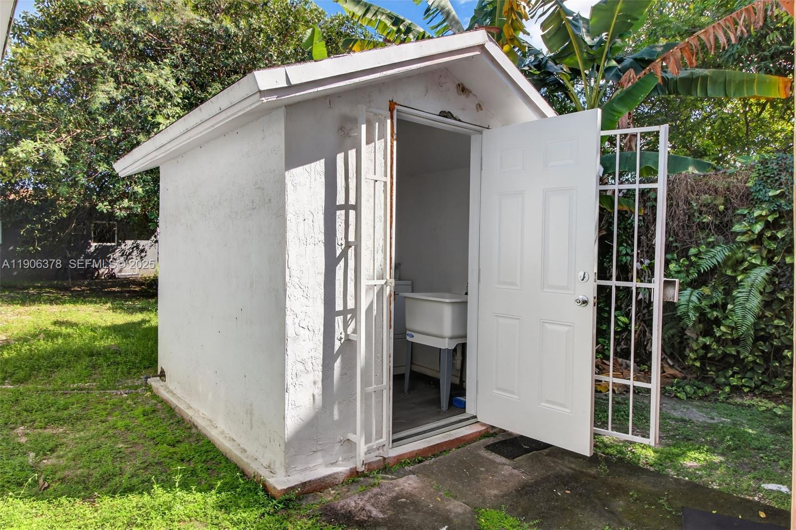 1864 Northwest 28th Street, Unit 1 Miami, FL 33142 - Photo 15 of 16 a view of a house with backyard and garden