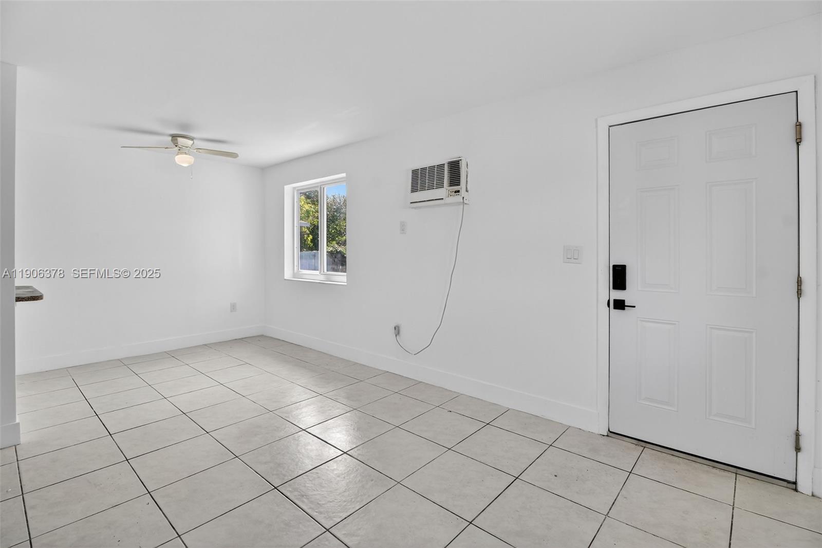 1864 Northwest 28th Street, Unit 1 Miami, FL 33142 - Photo 2 of 16 a view of an empty room with a window