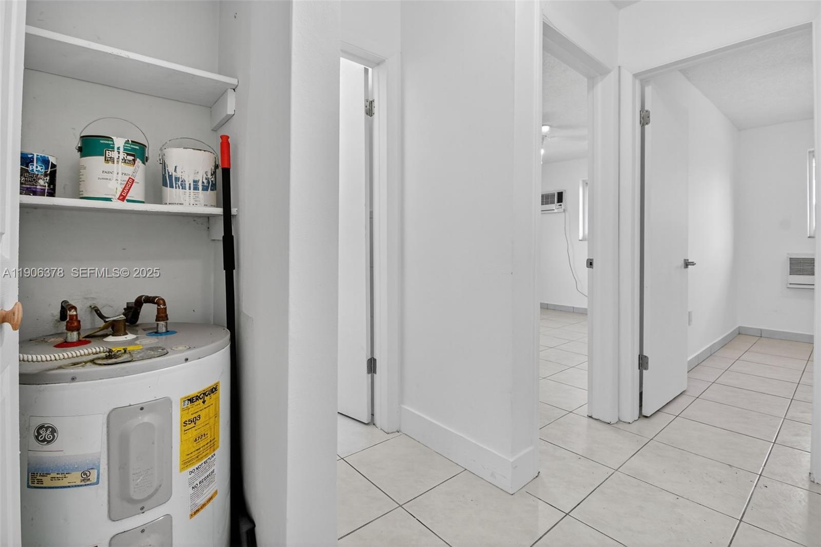 1864 Northwest 28th Street, Unit 1 Miami, FL 33142 - Photo 7 of 16 a workspace with white cabinets and wooden floor
