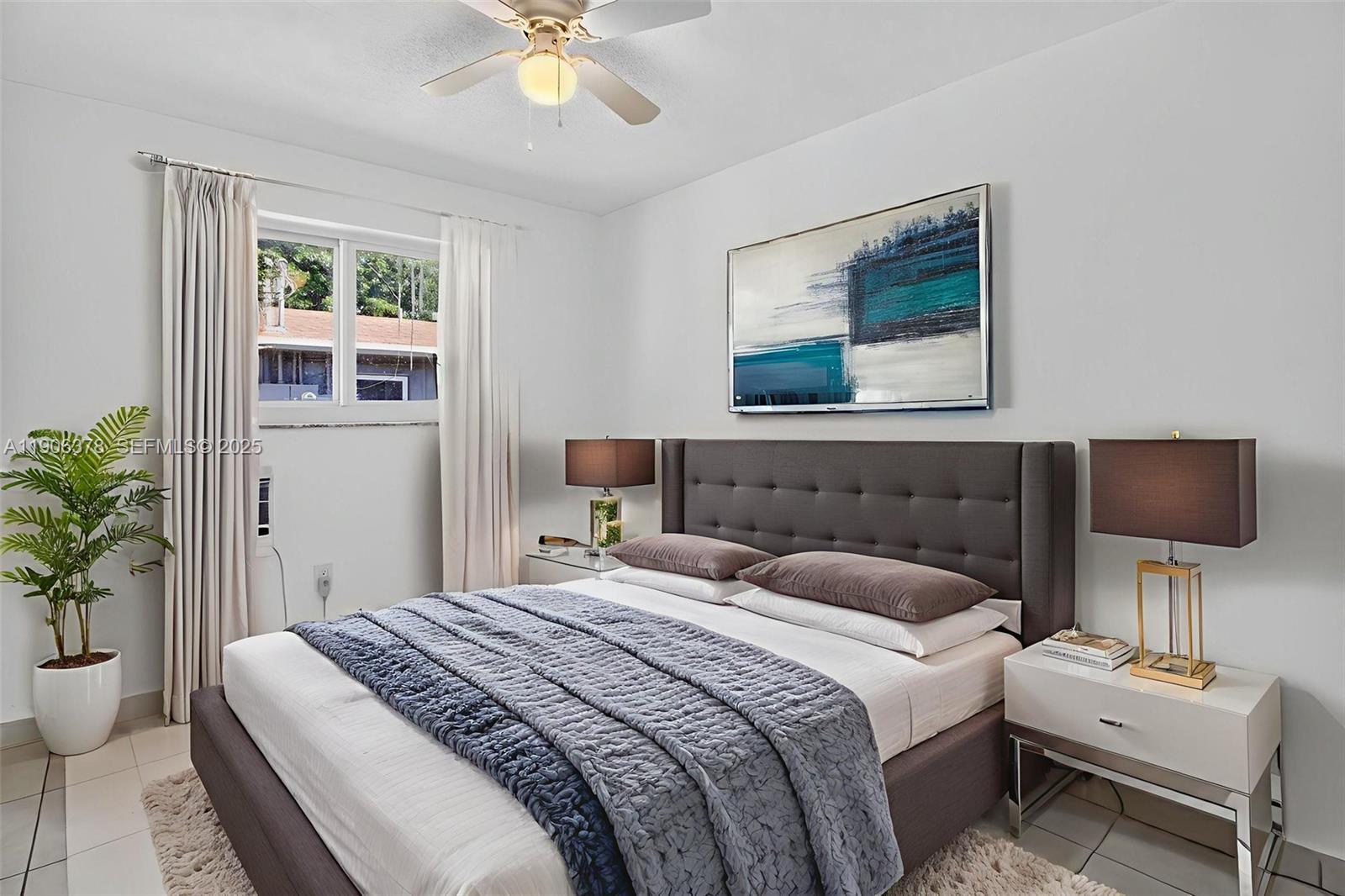 1864 Northwest 28th Street, Unit 1 Miami, FL 33142 - Photo 8 of 16 a bedroom with a bed and a potted plant