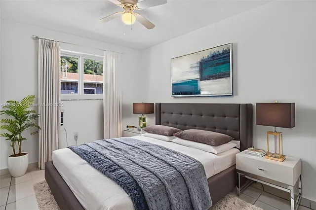 a bedroom with a bed and a potted plant