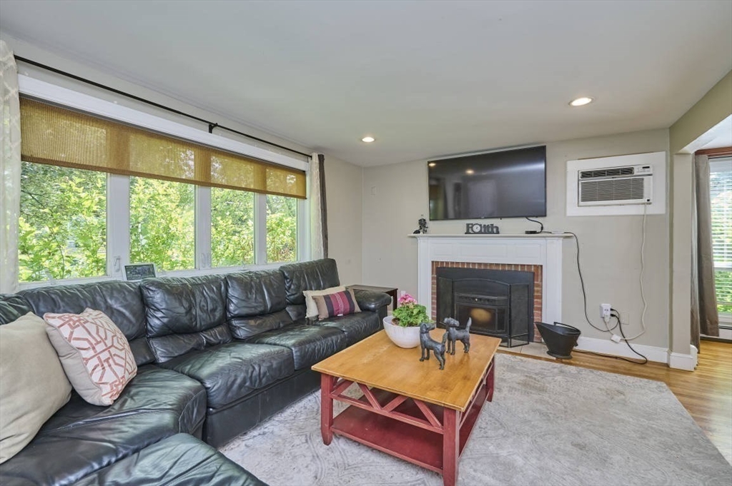 7 Lasallette Road Billerica, MA 01821 - Photo 12 of 35 a living room with furniture a flat screen tv and a fireplace