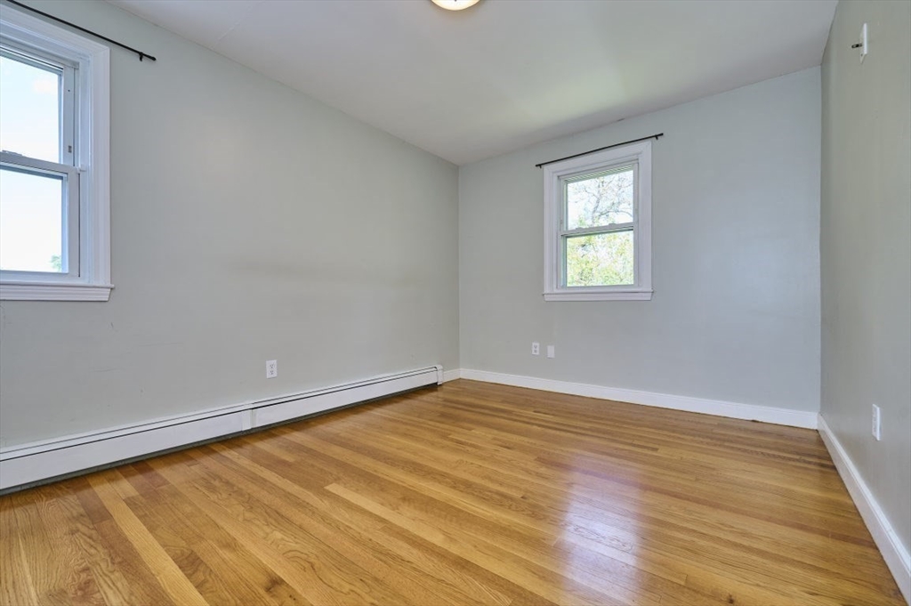 7 Lasallette Road Billerica, MA 01821 - Photo 17 of 35 an empty room with wooden floor and windows