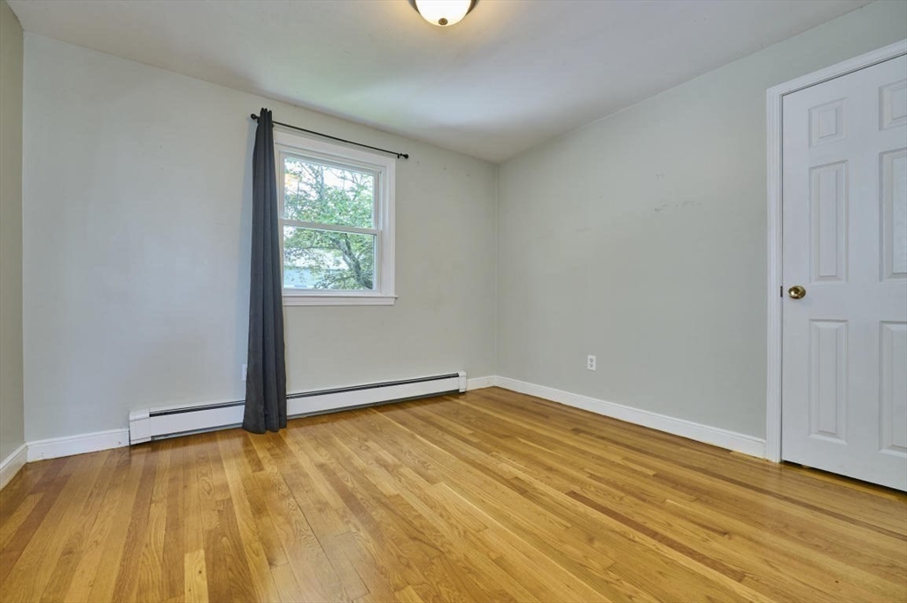 7 Lasallette Road Billerica, MA 01821 - Photo 19 of 35 a view of an empty room with wooden floor and a window