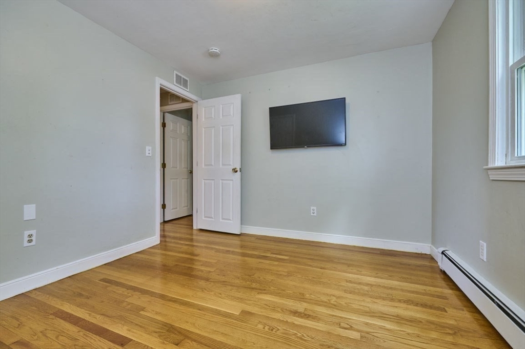 7 Lasallette Road Billerica, MA 01821 - Photo 20 of 35 a view of an empty room with wooden floor and a window