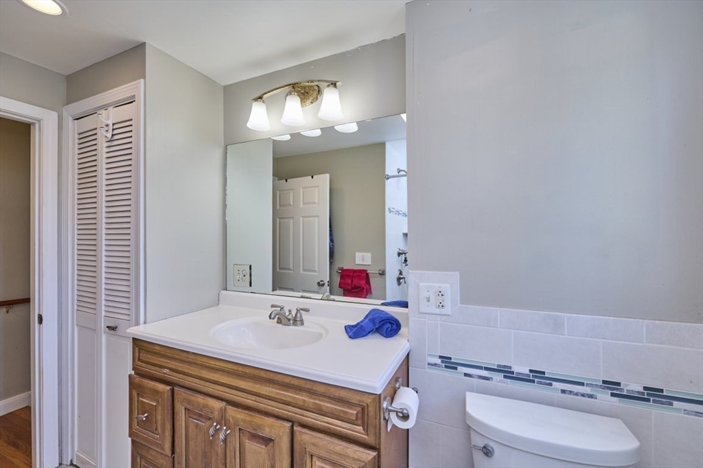 7 Lasallette Road Billerica, MA 01821 - Photo 21 of 35 a bathroom with a sink a toilet a mirror and shower curtain