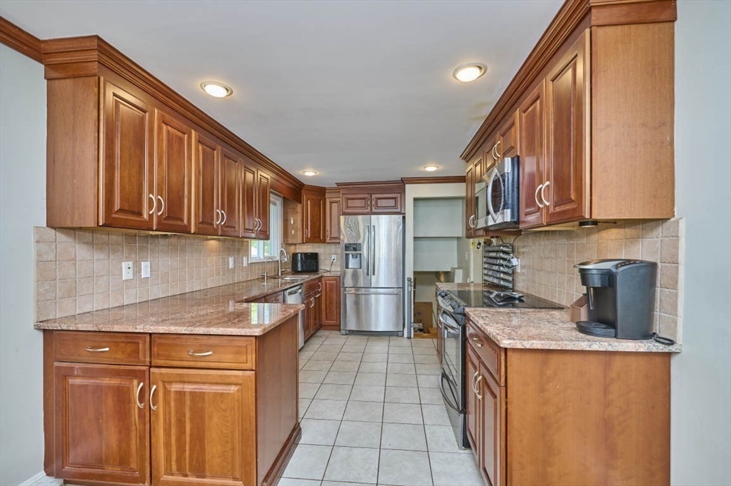 7 Lasallette Road Billerica, MA 01821 - Photo 7 of 35 a kitchen with stainless steel appliances granite countertop a stove a sink dishwasher and a refrigerator